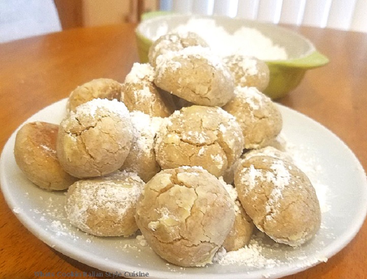 these are three crinkle cookies made with cinnamon flavors and buttery cookies rolled in powdered sugar with crinkles on top