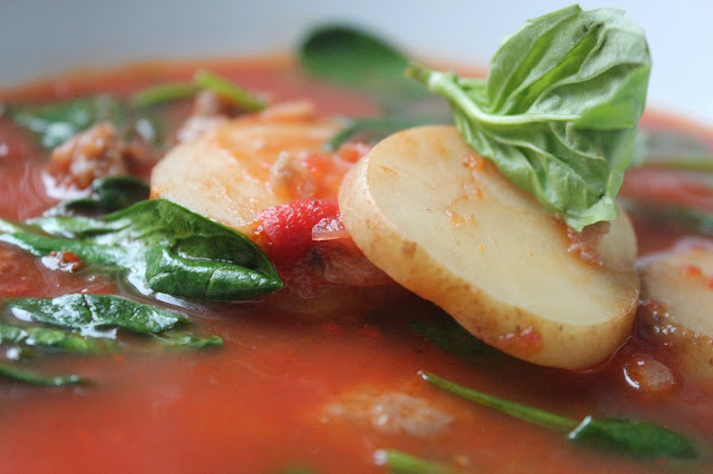 Tomato soup with sausage, spinach, and potatoes