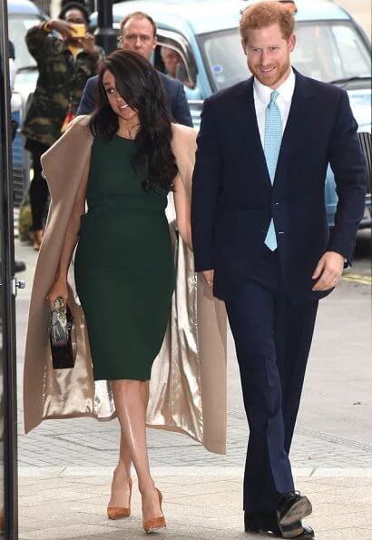 Meghan Markle carried Montunas mini guaria bag, She wore Sentaler wap coat, P.A.R.O.S.H. bow detail sleeveless dress