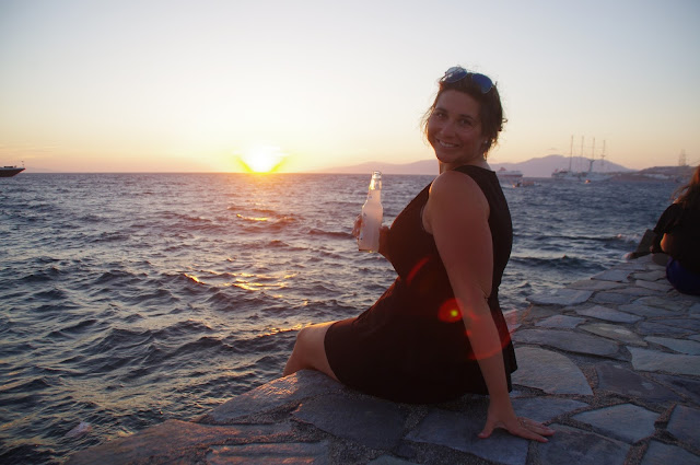 Girl having sunset drinks on Mykonos Island Girl having sunset drinks at Mykonos Islands