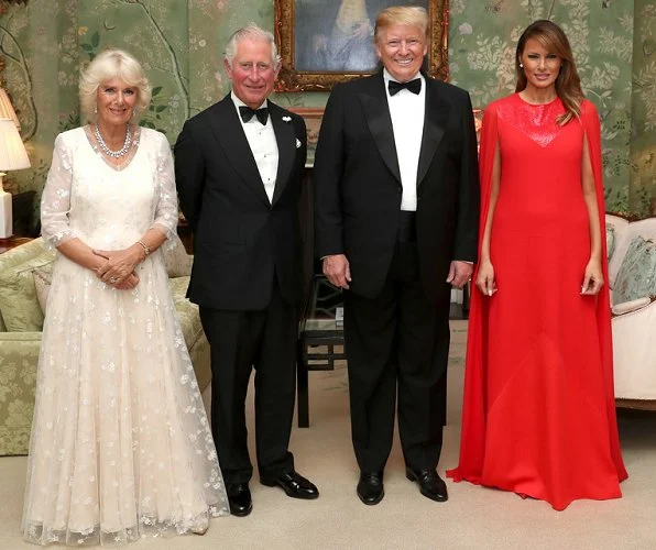 Melania Trump wore Givenchy Sequinned cape sleeve wool crepe gown. The Duchess wore a white lace dress, diamond necklace