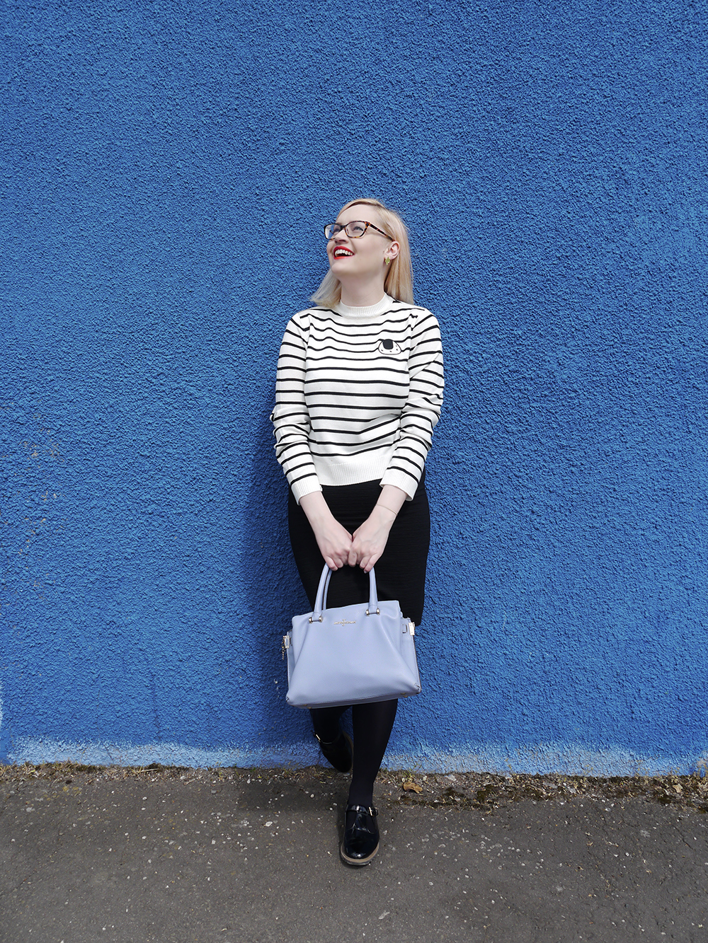 The Whitepepper black and white outfit by style blogger Wardrobe Converastions Scottish fashion blogger, Wardrobe Conversations, Jasper Conran bag from Debenhams, blue background, monochrome outfit inspiration, The Whitepepper top, sushi print, Dundee fashion shoot location, Dundee style blogger