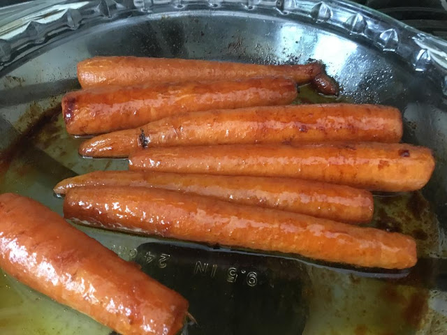 roasted whole carrots in a glass plate