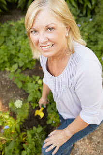 Photo of a Woman Planting Flowers in a Garden