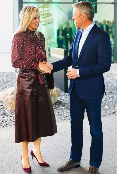 Queen Maxima wore Zara Polka dot blouse with bow detail, and burgundy ankle length wide leg high waisted leather trousers