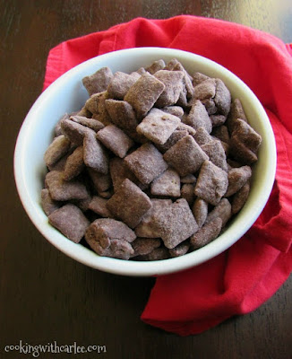 That childhood favorite snack of yours just got an upgrade! Whether you call it puppy chow, muddy buddies or just plain good, you have to try this brownie batter version! bowl of chocolate and peanut butter brownie batter puppy chow ready for snacking