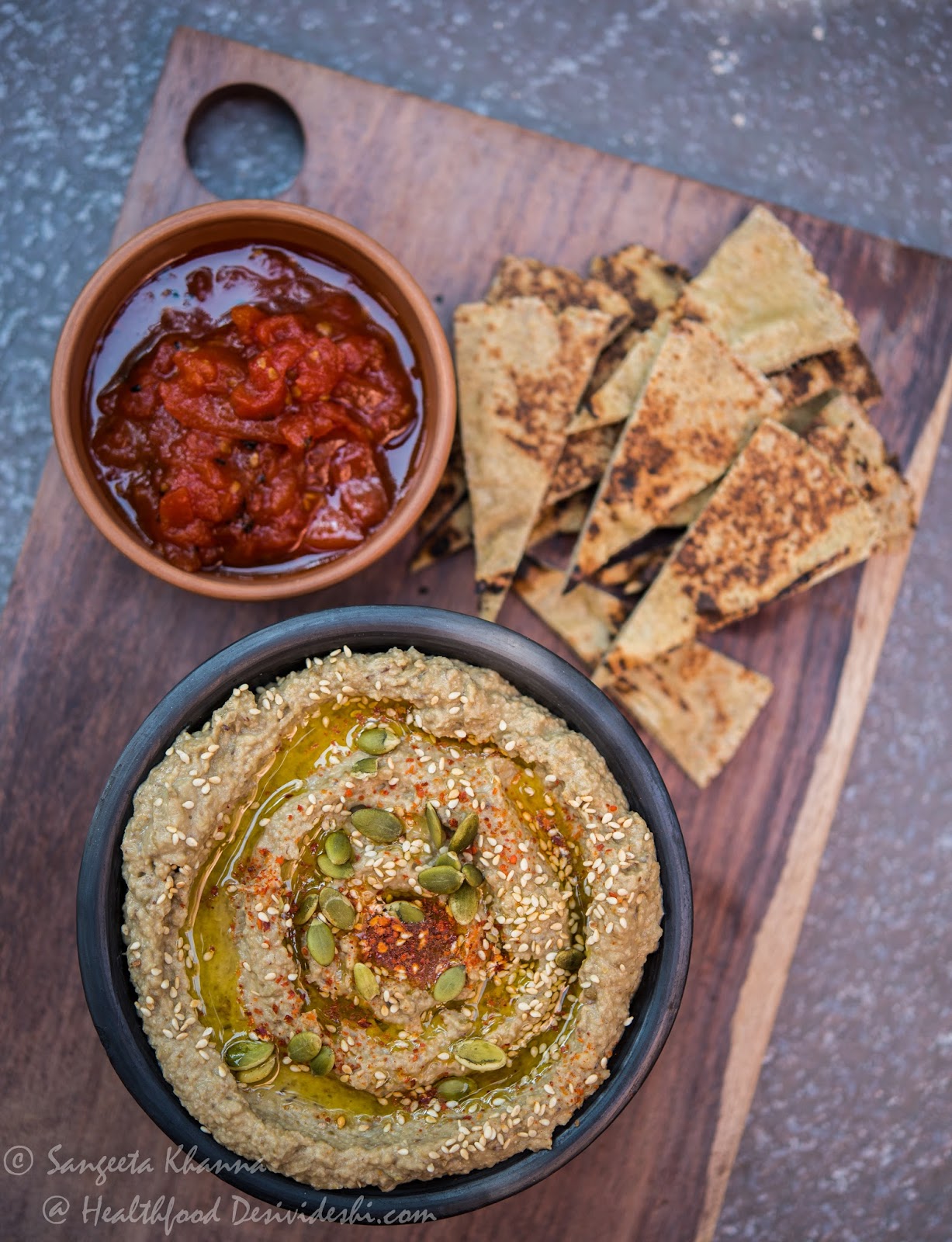 green mung bean hummus with green pitted olives and mixed seeds tahini
