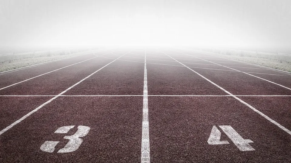 Empty running track and shrouded by fog Empty running track and shrouded by fog