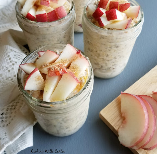 Creamy, dreamy and delicious, these overnight oats make the morning so easy. Just grab and jar and a spoon and hit the road! If you want to serve to guests, you can dress them up with a few more fresh chopped peaches, a drizzle of honey and a sprinkle of cinnamon. Either way, you'll be glad you did it! jars of overnight oats topped with white peach pieces, cinnamon and honey
