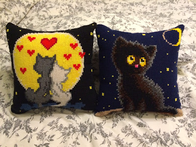 Pillows with cats embroidered on them