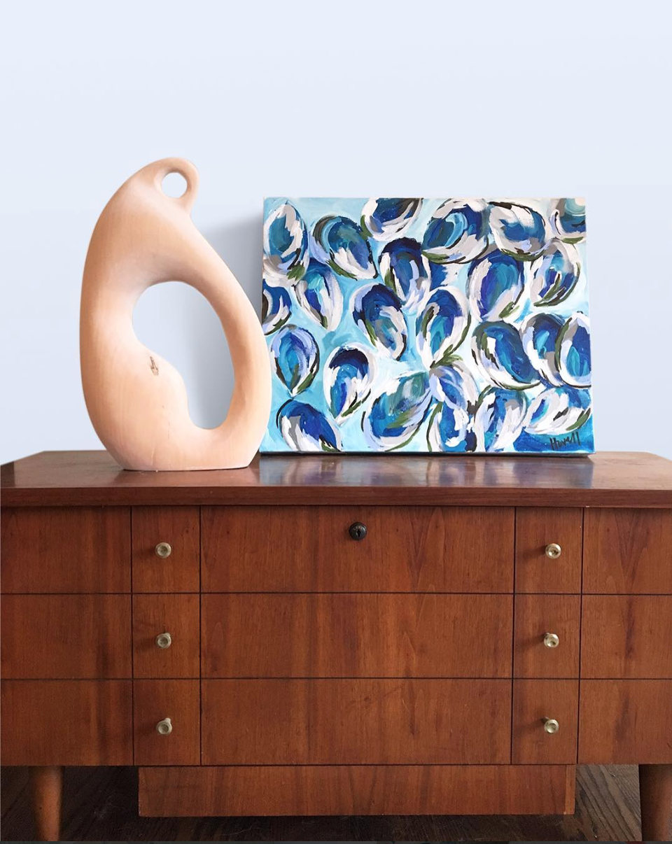Kim Hovell art styled on a credenza