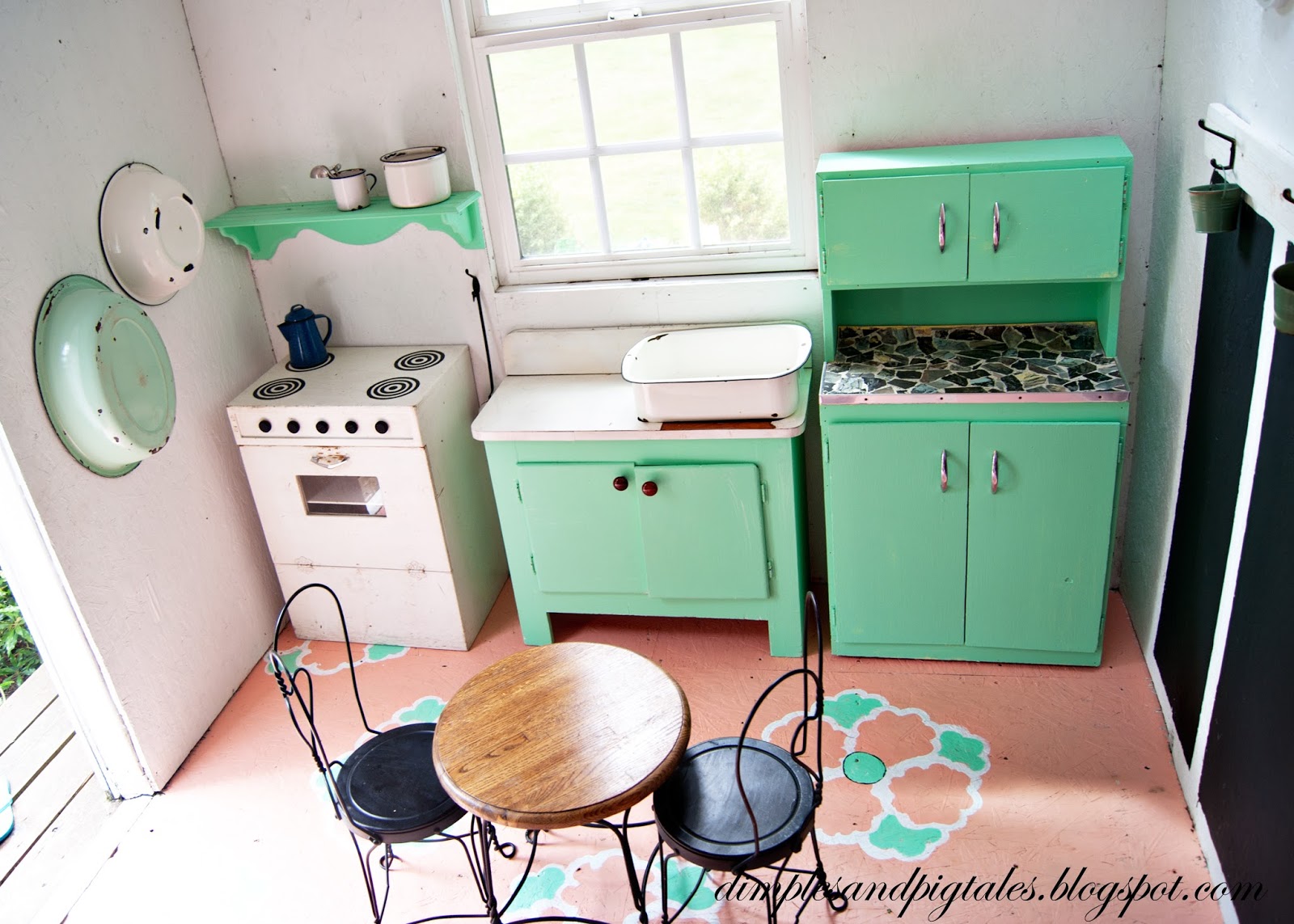  Playhouse with mint green cabinets, coral painted floor, chalkboard wainscoting and vintage accessories.