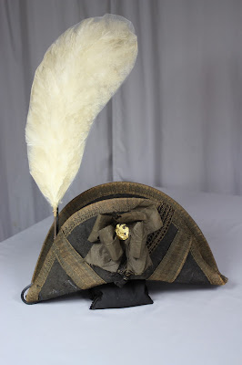 The display mount with chapeau and plume Exhibit mount to display chapeau and plume together. each mount is separate, yet works together. Spicer art Conservation art conservator, preservation, repair, military collectibles, artifacts, antiques, textiles objects and paper conservation.