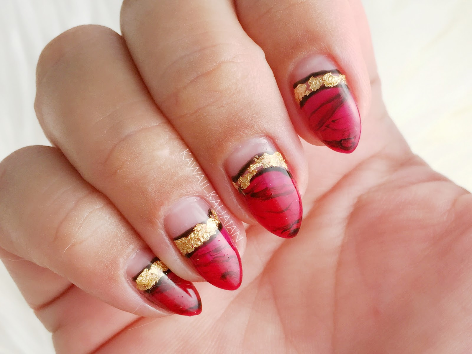 red and gold marble nail design