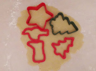 Christmas cookie cutters pressed into dough