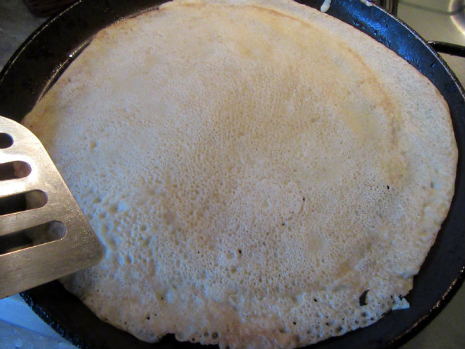 Shrove Tuesday crêpes by Laka kuharica: ladle in some batter, tilt and swirl so it coats the bottom.