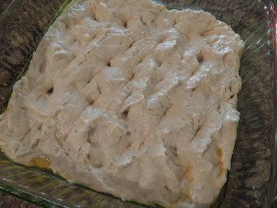 poking holes in the focaccia dough