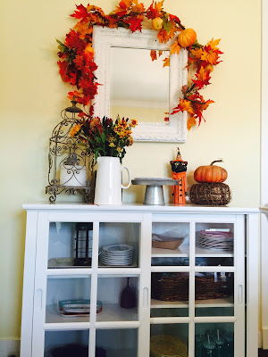 Fall decorated hutch, Ikea shelving, black and white dishes, Orange Halloween dishes