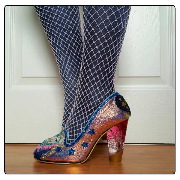 Wearing Irregular Choice Lady Misty side side view of holographic unicorn lucite heels on foot