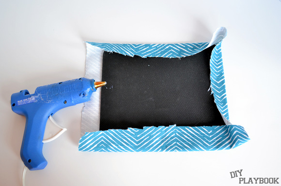 Use a hot glue gun to glue down the fabric border to the bottom of the mousepad