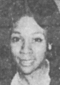Black and white headshot of a Black woman in her 30s, with large almond-shaped eyes and neatly coiffed hair