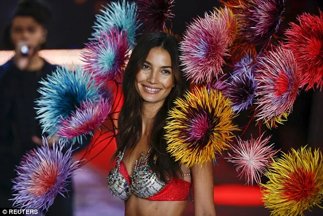 Lily Aldridge mesmerized in the 2015 Fantasy Bra and an intricate display of flowers