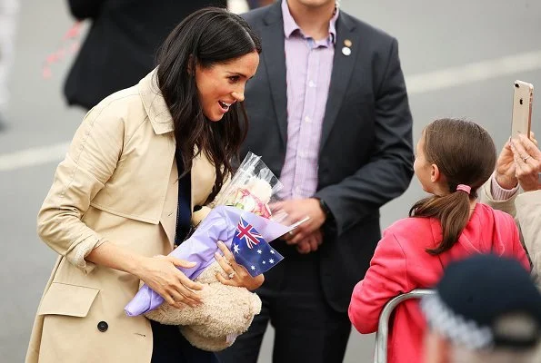 Meghan Markle wore a folded sail dress by Australian fashion designer Dion Lee, Martin Grant coat, Gucci Sylvie bag, Manolo Blahnik suede pumps