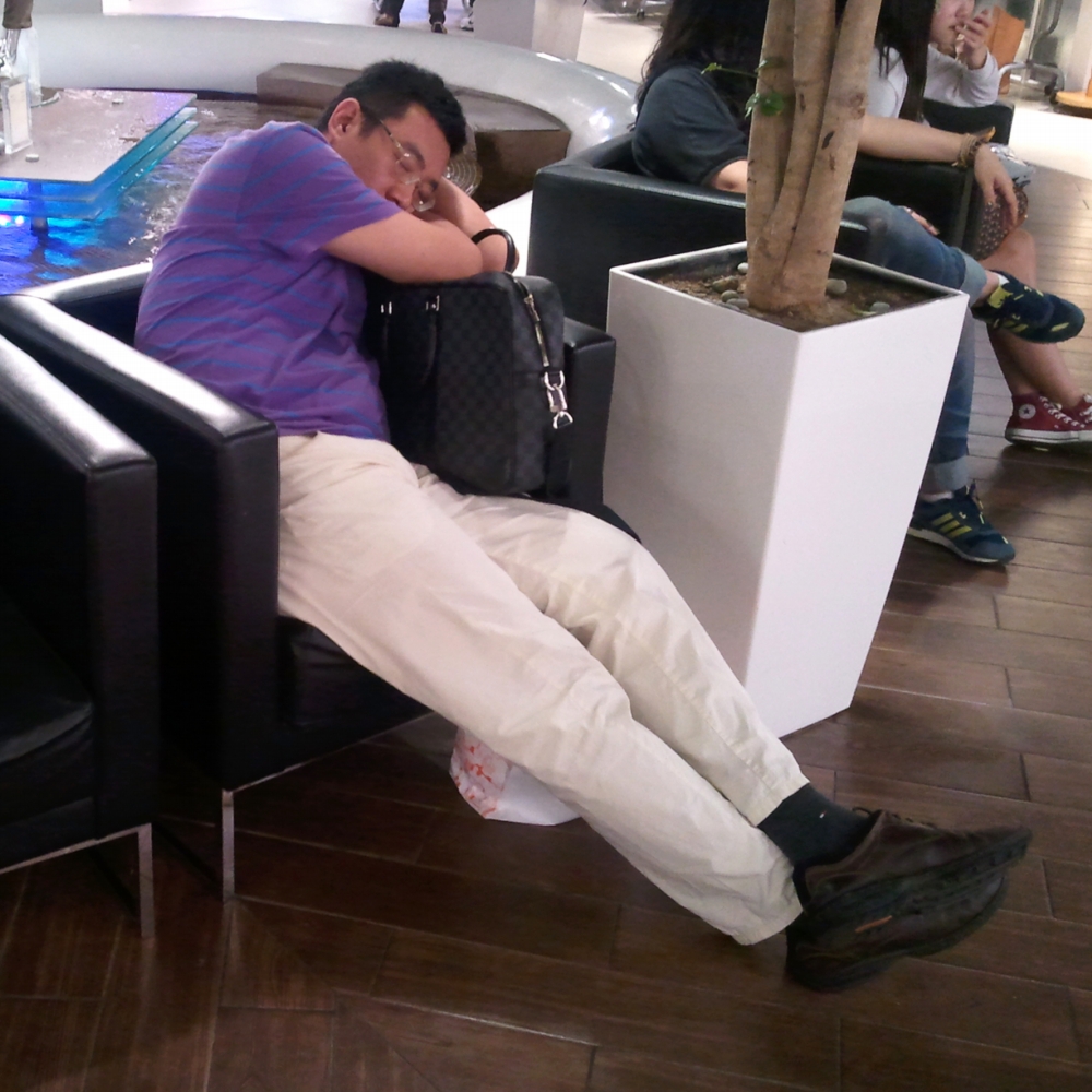 Hombre coreano durmiendo en un centro comercial