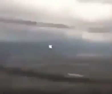 Here's an image showing another UFO as it literally streaks past the plane.