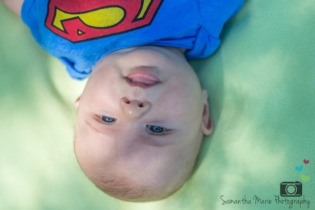 smiling baby in Superman shirt