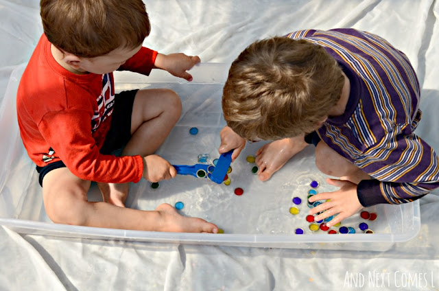 Two kids playing in a magnetic sensory bin