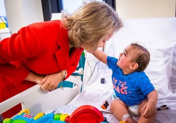 Queen Mathilde visited Queen Fabiola Children's University Hospital. The Queen wore a double breasted orange blazer by Ralph Lauren