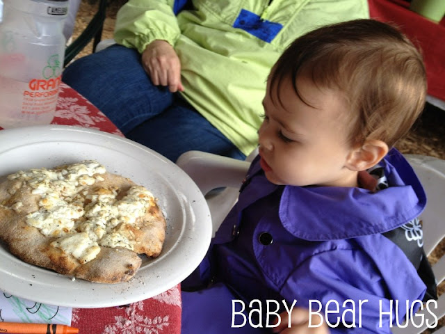 baby eating pizza made with goat cheese