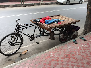 A little bike maintenance on the side of a very busy street