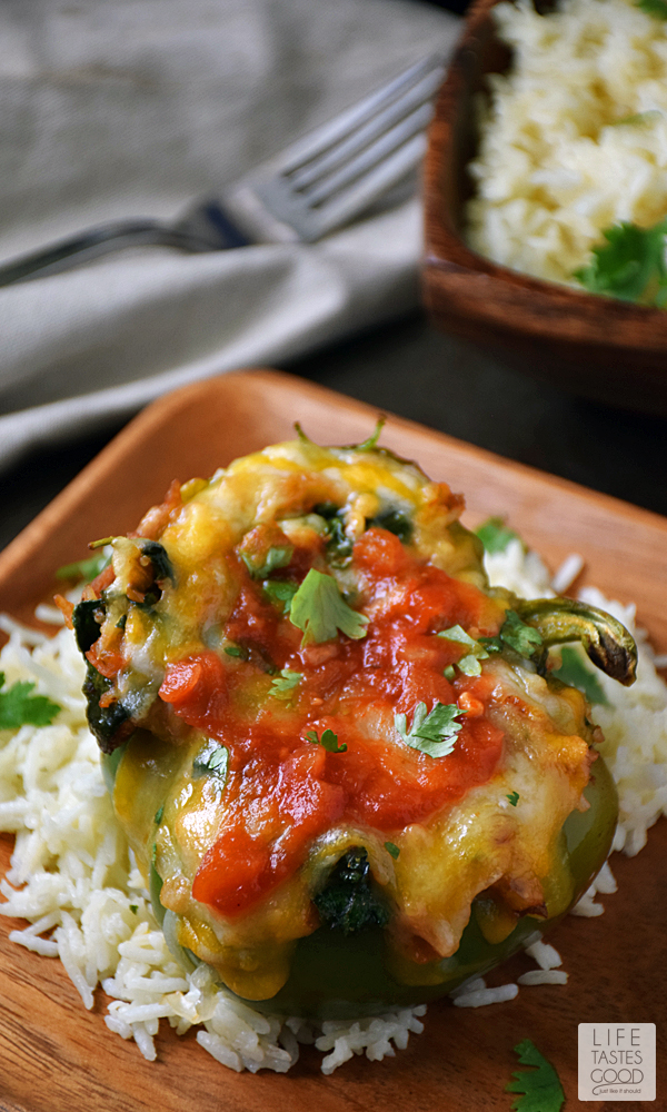 Green Peppers | by Life Tastes Good are stuffed with a mixture of turkey sausage, spinach, fresh herbs & Basmati rice in a spicy salsa topped off with ooey gooey cheese are easy to make and packed full of exciting flavors. #LTGrecipes