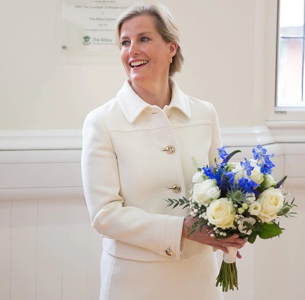 The Countess of Wessex wore Prada Gabardine wool jacket, skirt and suede pointtoe pumps. Sophie Habsburg clutch bag. Gold hoop earrings. Skagen Ladies watch