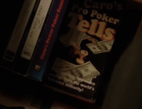 Mike McDermott retrieves money from a copy of Mike Caro's 'Poker Tells' in 'Rounders'