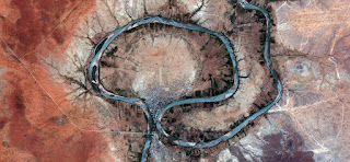 The greeting of the river, surreal, meandering water in the desert, abstract landscapes of deserts of Africa from the air, red texture stone collection of Abstract Naturalism Munimara abstract landscapes of deserts of Africa from the air, red texture stone collection of Abstract Naturalism Munimara