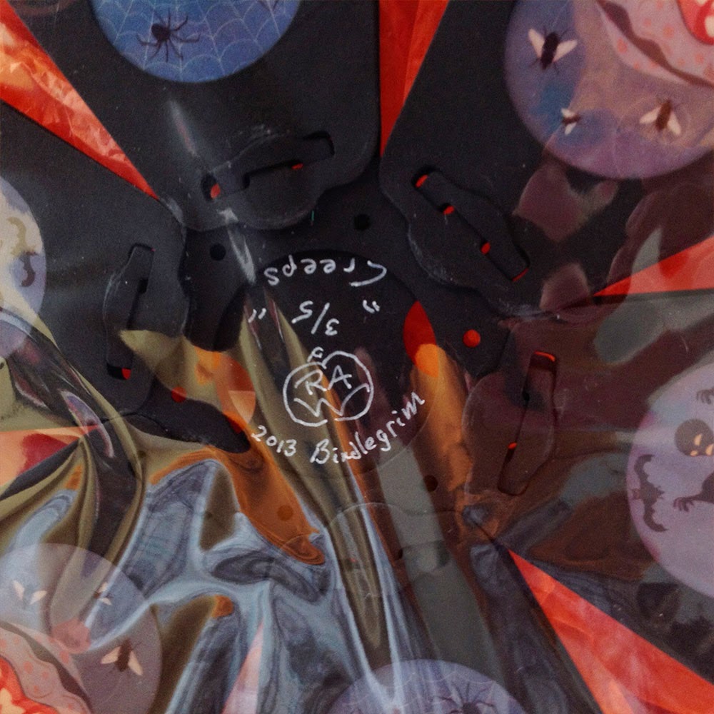 Close-up view of signed limited-edition holiday lantern by Halloween artist and designer Bindlegrim