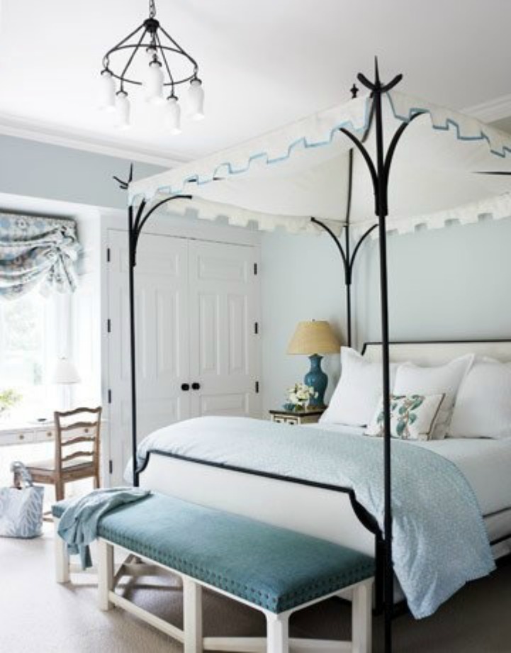 Coastal bedroom with iron canopy four poster bed