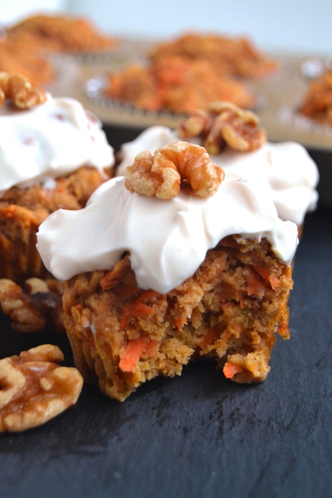 Greek Yogurt Carrot Cake Muffins are whole-grain, super moist and topped with a delicious Greek yogurt cream cheese frosting and walnuts! www.nutritionistreviews.com