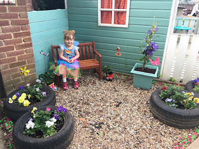 Sophie sitting on the bench in "Jessica's garden"