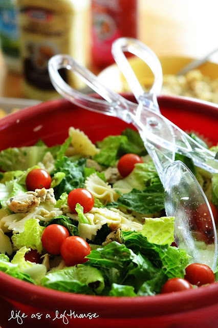 Chicken Bow Tie Pasta Salad is filled with grilled chicken, bow tie pasta, romaine lettuce and cherry tomatoes tossed in salad dressing. Life-in-the-Lofthouse.com