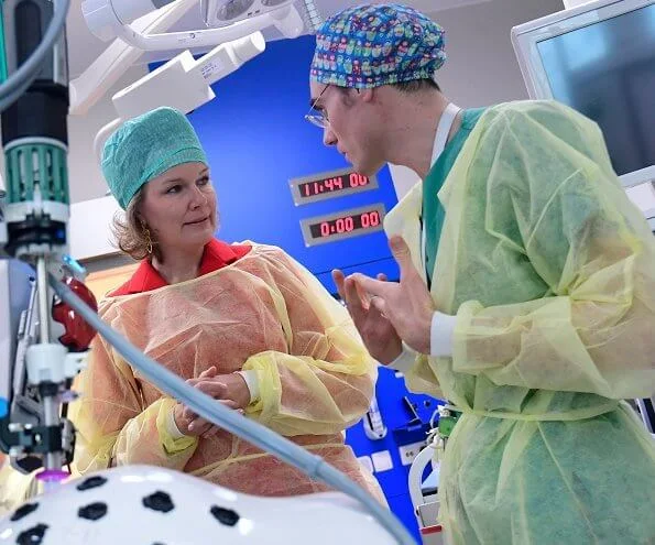 Queen Mathilde visited Queen Fabiola Children's University Hospital. The Queen wore a double breasted orange blazer by Ralph Lauren