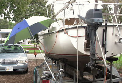 Sun Shade in the Rain - hull waxing on SV HideAway
