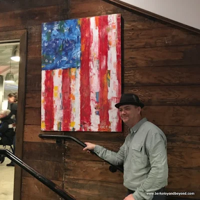 owner Andrew Pryfogle with flag painting at Tips Roadside in Kenwood, California