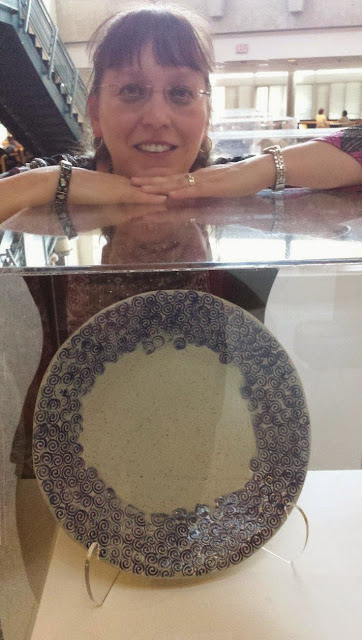 Lily with her slab built pottery ceramic platter with swirly hand stamped pattern.