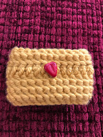 yellow cup cozy with heart bead flat