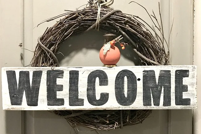 mini diy pumpkin on welcome sign