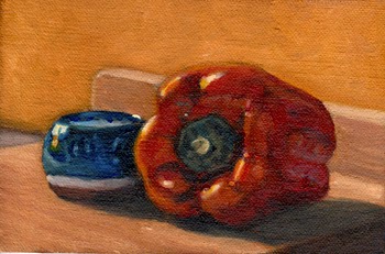Oil painting of a blue and white glazed terracotta pot beside a red pepper, both sitting on a wooden chopping board and illuminated by the afternoon sunshine.